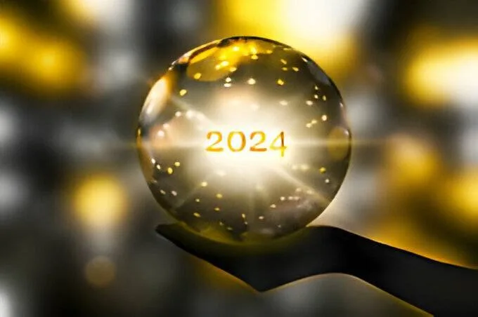 2024 predictions and future forecasting concepts with glowing crystal ball