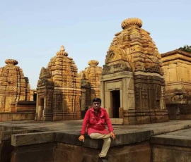 Ramapada Acharjee at an ancient Hindu temple exploring Vedic heritage and spiritual wisdom