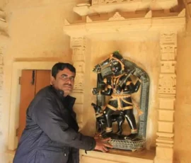 Ramapada Acharjee seeking blessings from a divine deity at a historic temple during his spiritual travels