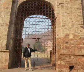 Ramapada Acharjee exploring ancient Vedic heritage and historic architecture at a sacred site during his spiritual expedition.