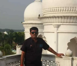 Professional consultant Ramapada Acharjee at a historic landmark during a spiritual research tour