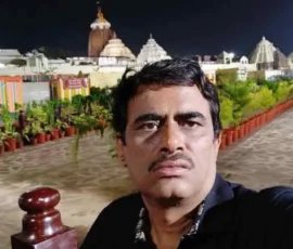 Ramapada Acharjee at the illuminated Jagannath Temple, Puri, during a spiritual night visit