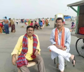 Ramapada Acharjee with a spiritual colleague at a holy river ghat during a pilgrimage tour