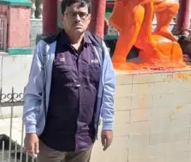 Astrologer Ramapada Acharjee seeking blessings from Lord Hanuman at a sacred temple during his pilgrimage