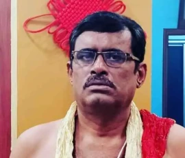 Spiritual expert Ramapada Acharjee in traditional Vedic attire reflecting divine energy and wisdom